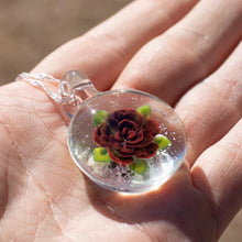 Load image into Gallery viewer, A glass pendant with a red rose inside and cremation ashes
