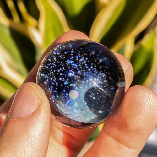 Large glass space marble with an opal planet