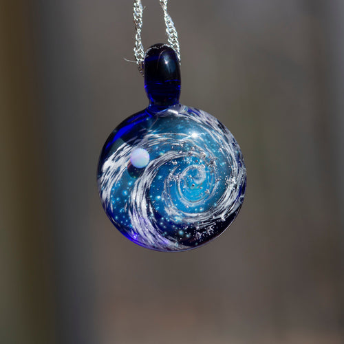 Glass pendant with galaxy swirl and an opal planet inside