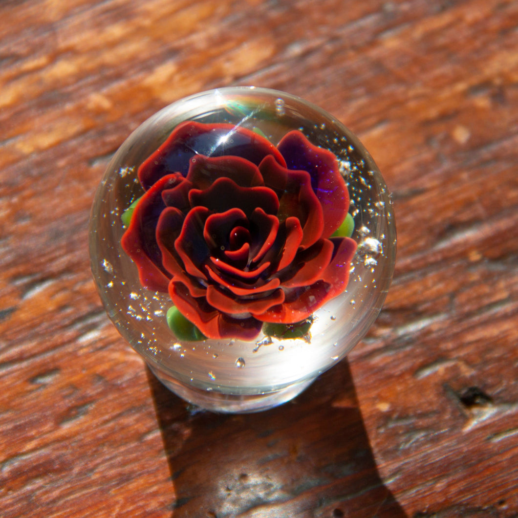 Glass marble with red rose inside