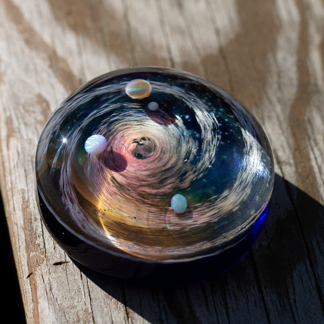 Glass paperweight with galaxy swirl and opal planets